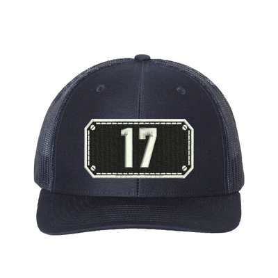 Richardson Trucker Hat.  Black Shield design with your fire station number embroidered in the shield.  Hat color navy/navy.