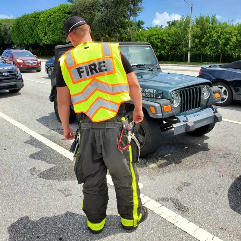Firefighter on Duty Wearing FIRE UltraBright Orange 6-Point Breakaway Public Safety Vest