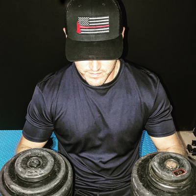 Firefighter at Gym Wearing Thin Red Line Axe Flag Richardson Hat